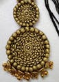 Body jewelry,Yellow,Religious item,Art,Circle,Jewellery,Badge,Metal,Close-up,Font