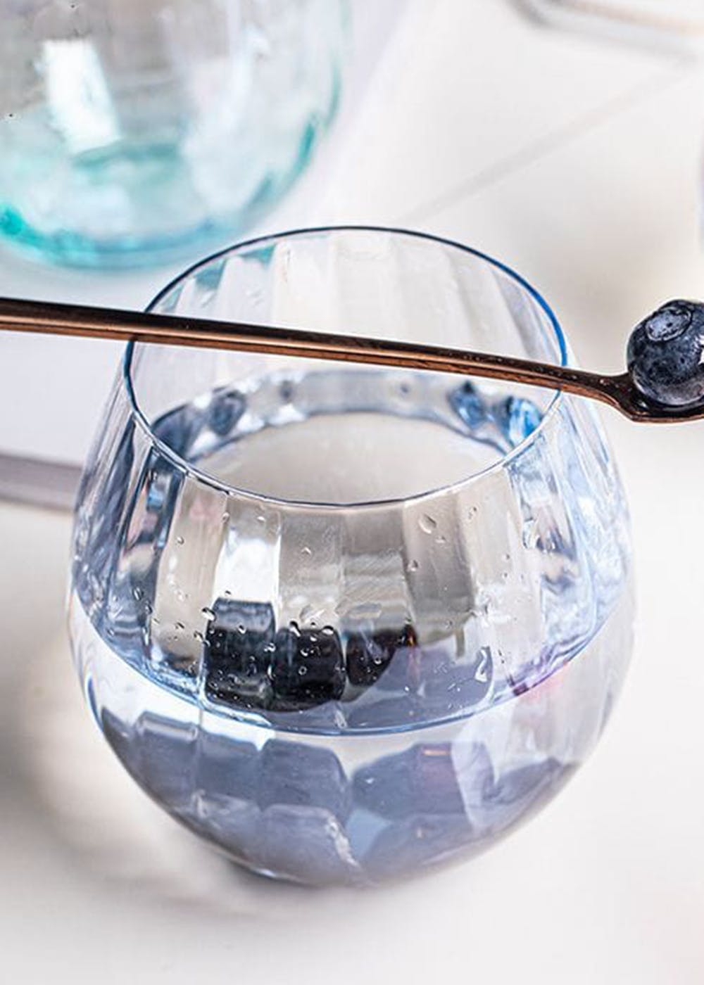 Drinkware,Hood,Liquid,Blue,Automotive lighting,Stemware,Barware,Perfume,Aqua,Serveware
