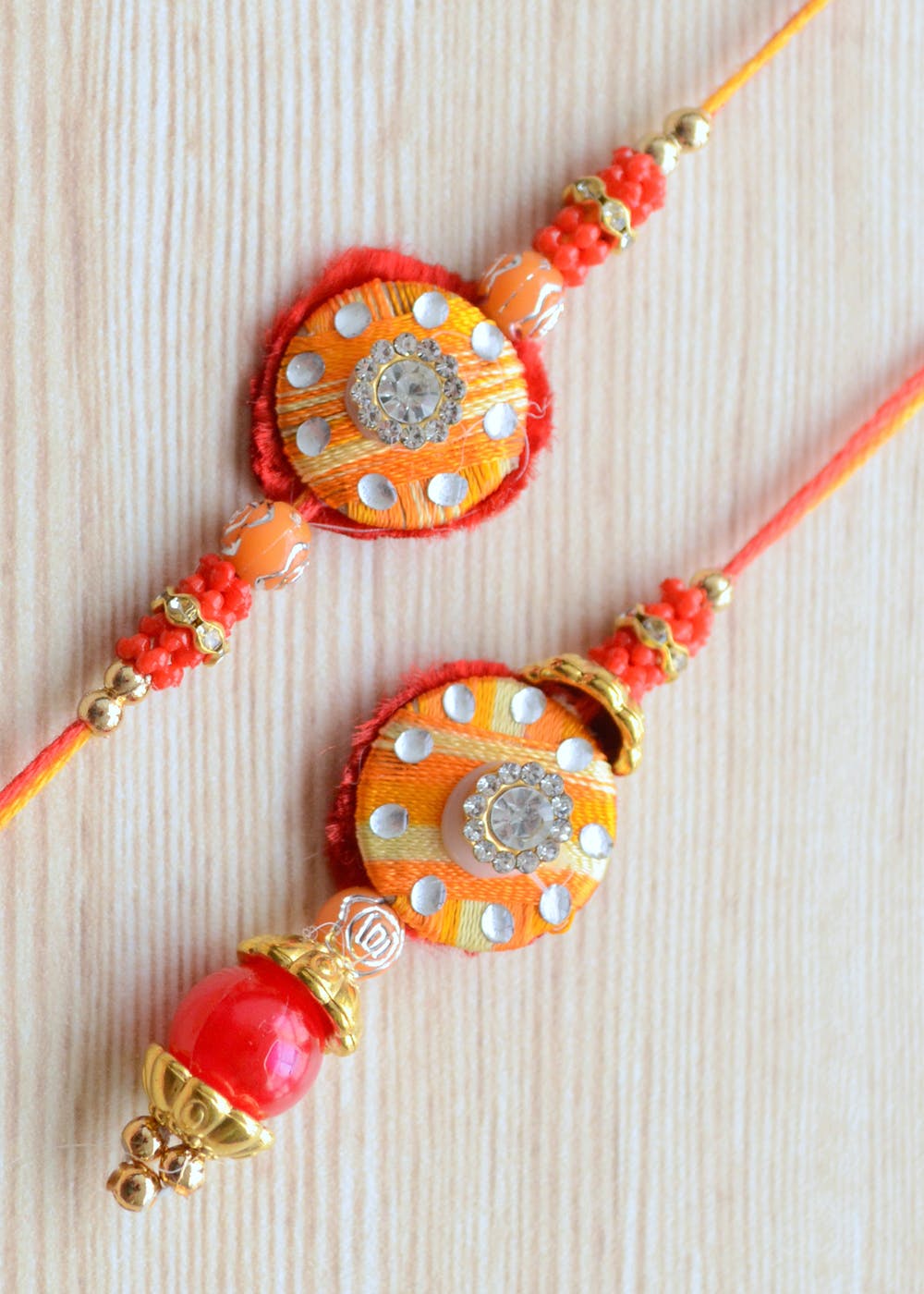 Get Red Orange And Gold Traditional Small Lumba And Rakhi at ₹ 259 ...